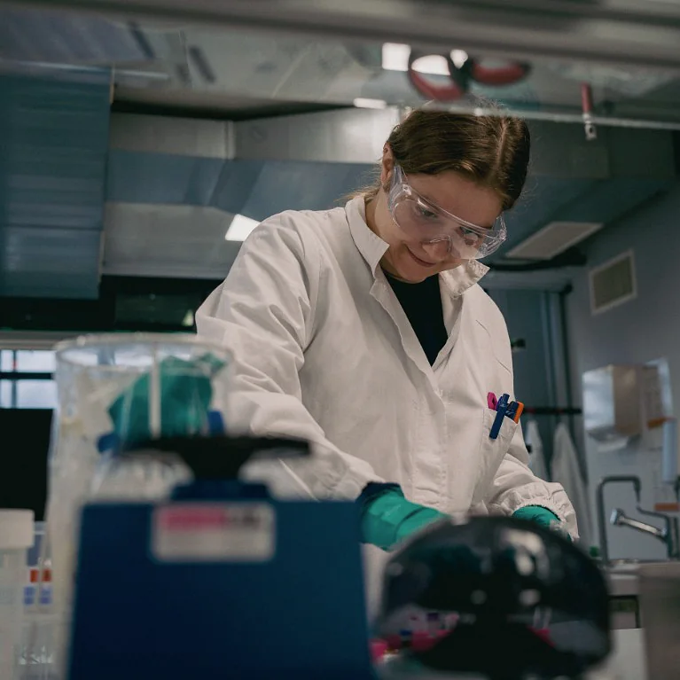A Peptone scientist preparing samples at a laboratory bench