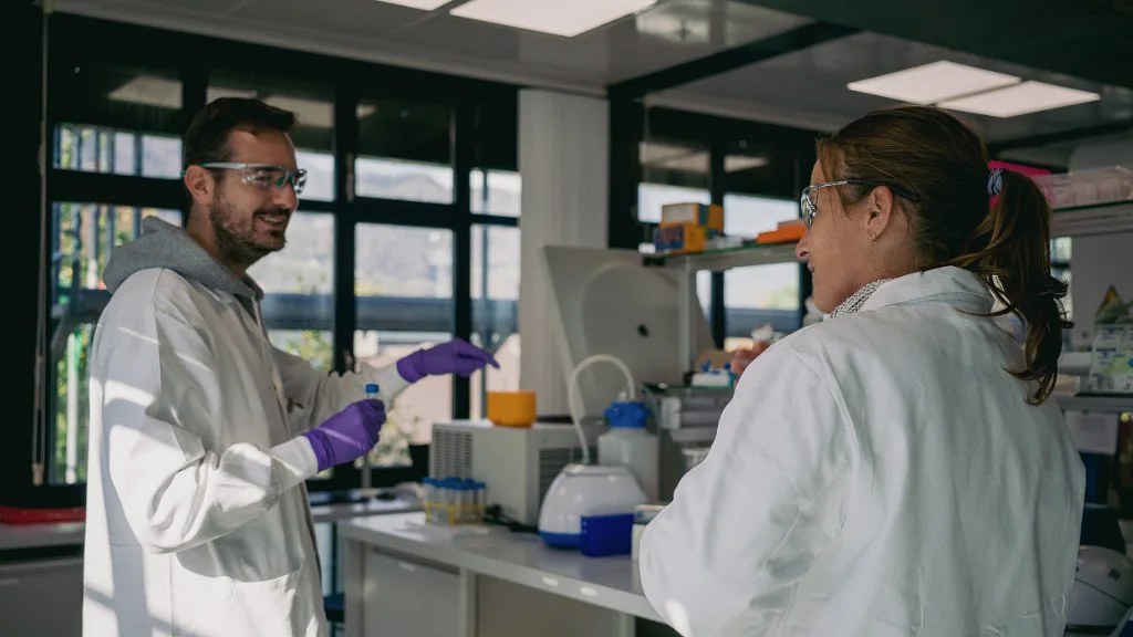 Two Peptone scientists discussing an experiment in the laboratory